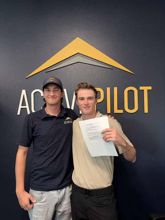 Mitch Rittenhouse with student Devin holding a multi-rating certificate