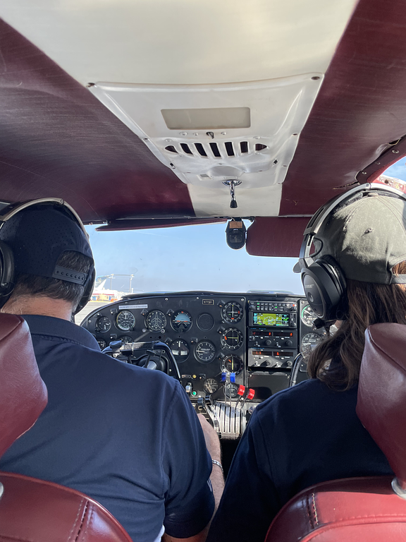 Mitch Rittenhouse with a student inside the cockpit during flight training