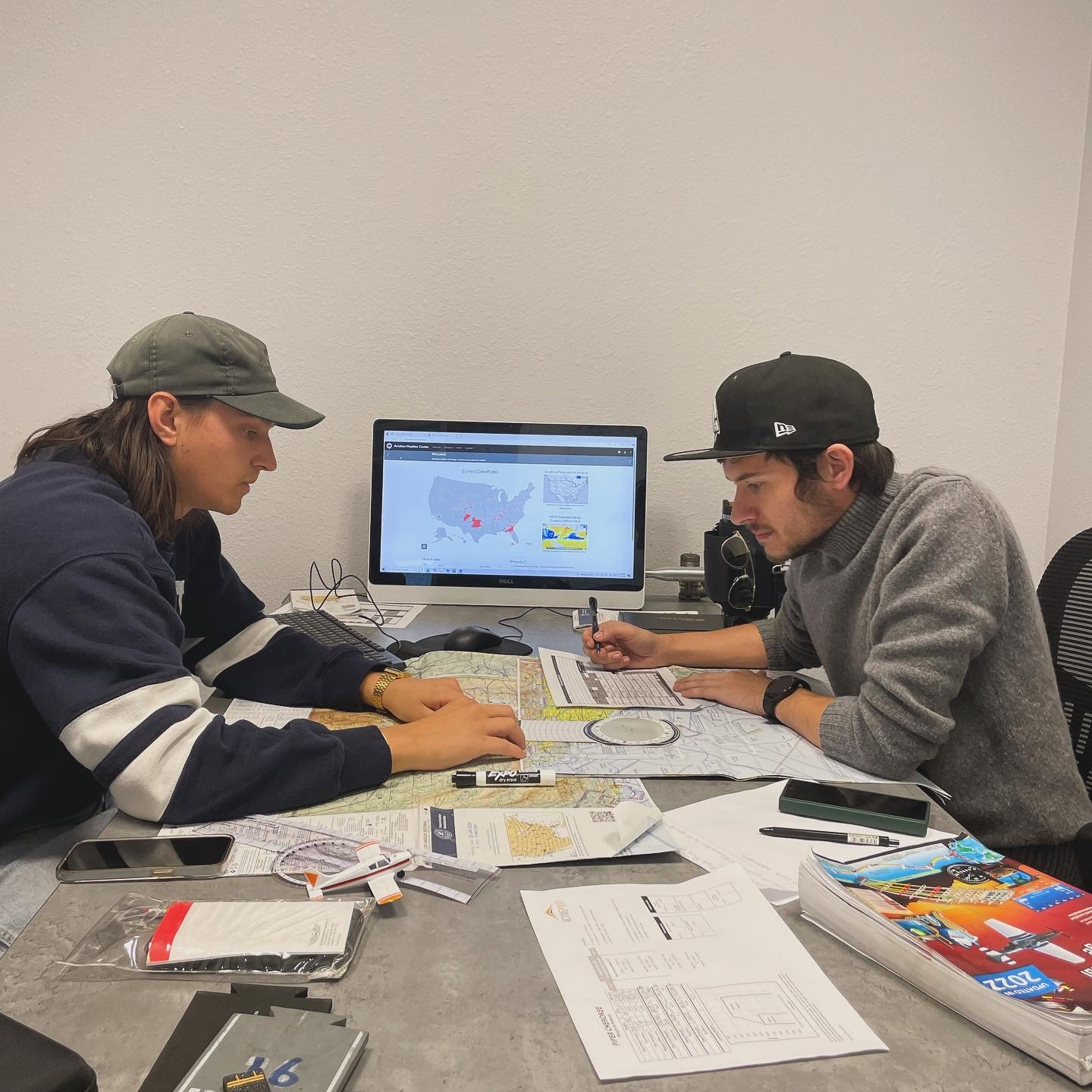 Flight instructor and pilot student reviewing training plans at ActivePILOT