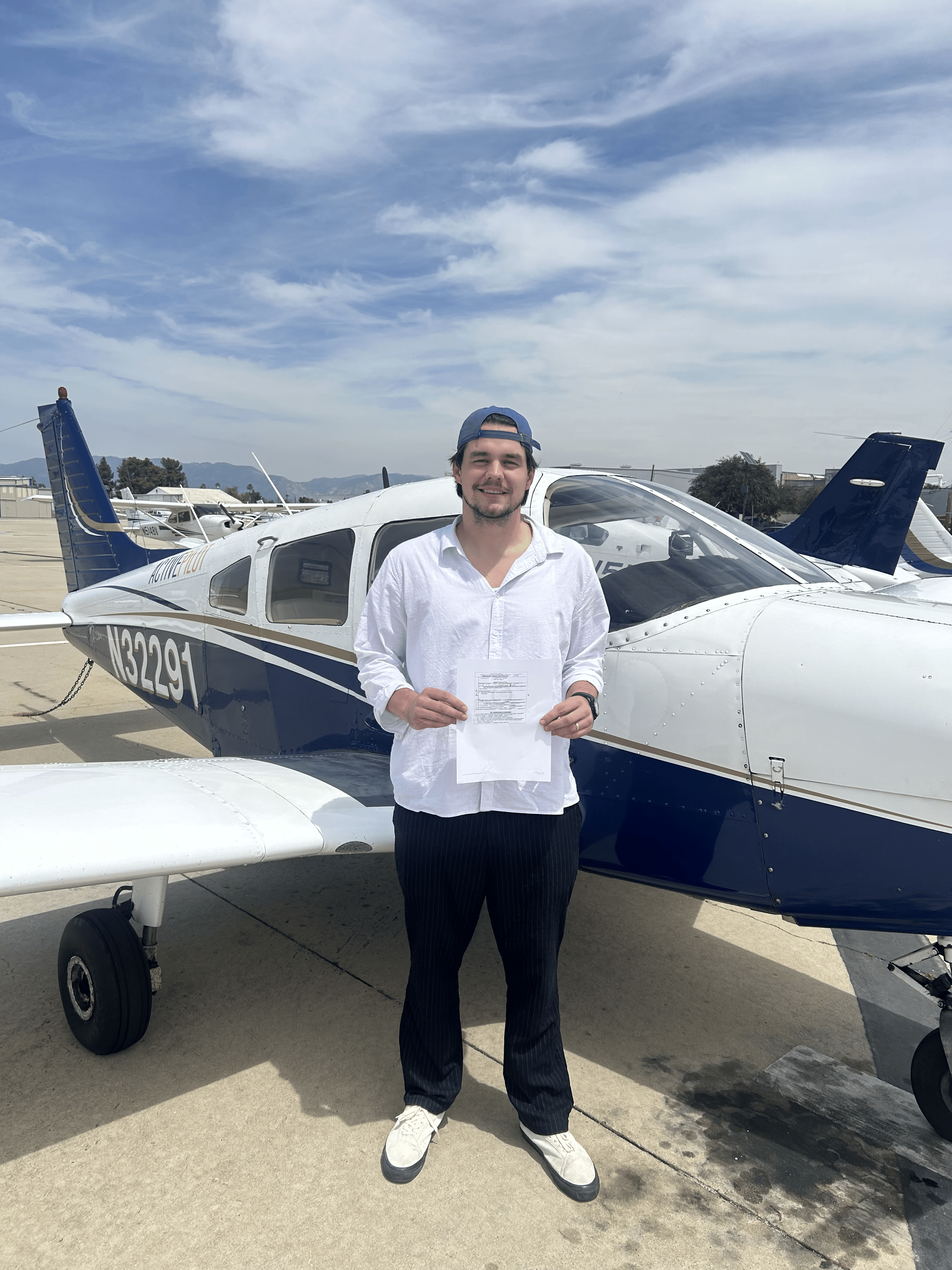 Caleb Walden holding his private pilot certificate after passing his checkride at ActivePILOT