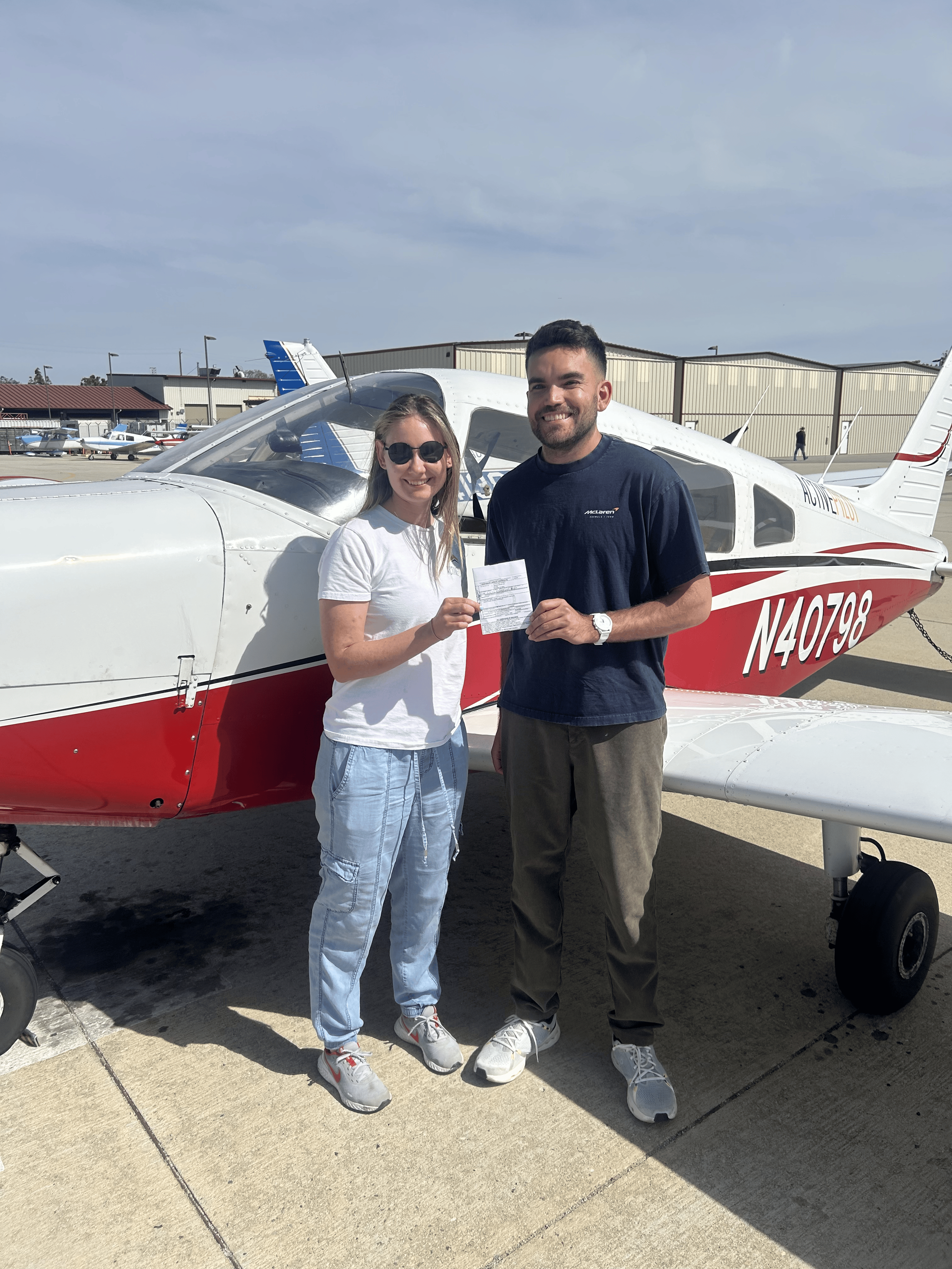 Josh Schmitz celebrating an instrument rating checkride pass with CFI Caelia Moore at ActivePILOT
