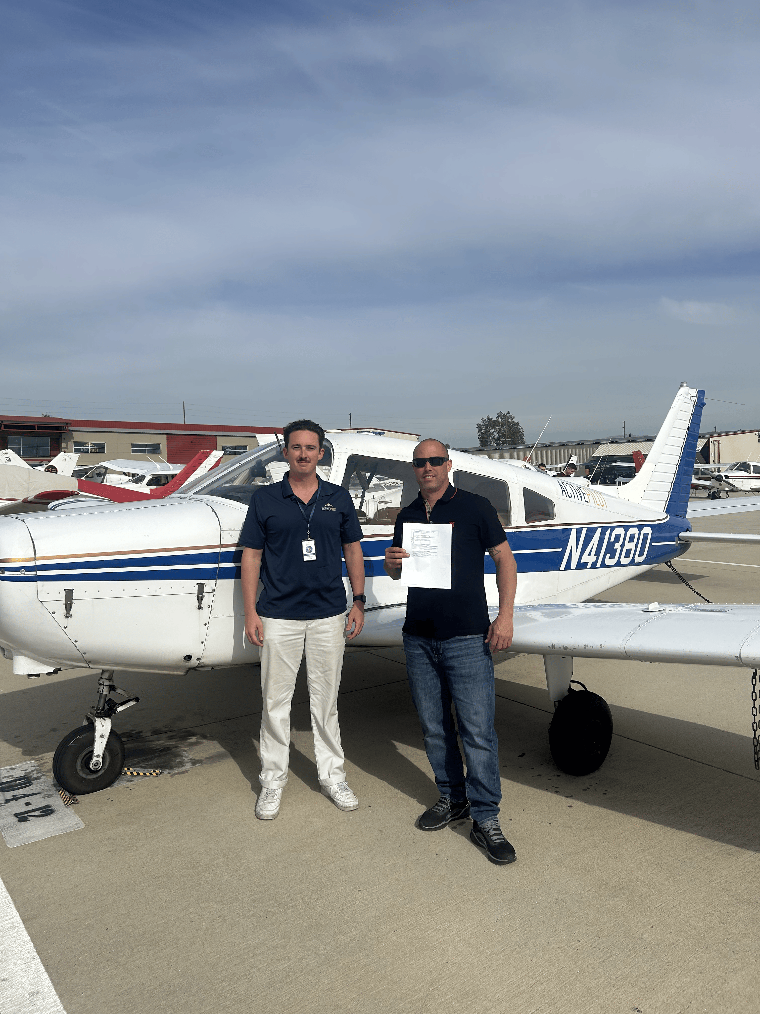 Lee Cooke celebrating an instrument rating checkride pass with CFI Carter Randolph at ActivePILOT