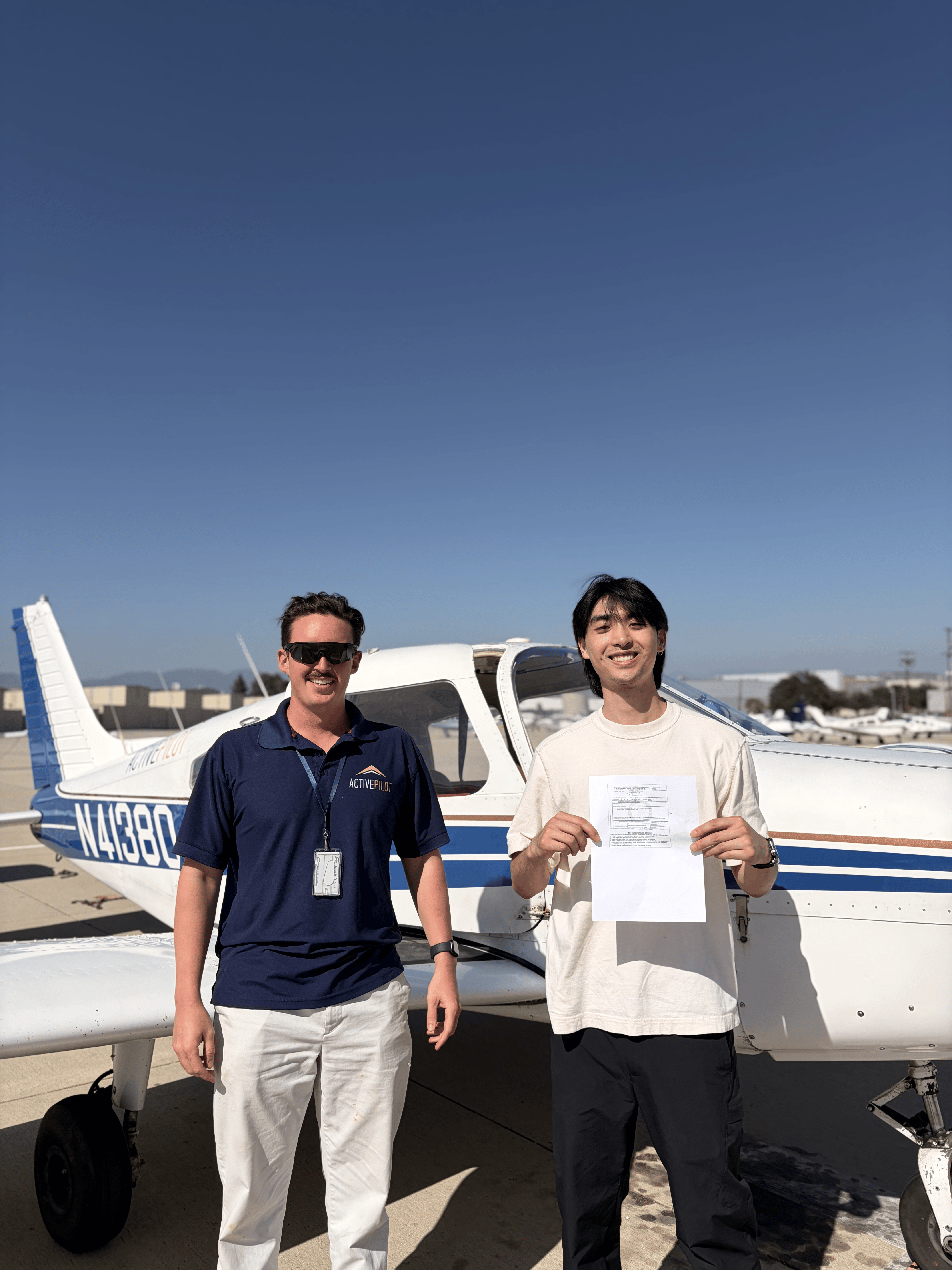 Sam Kim celebrating an instrument rating checkride pass with CFI Carter Randolph at ActivePILOT